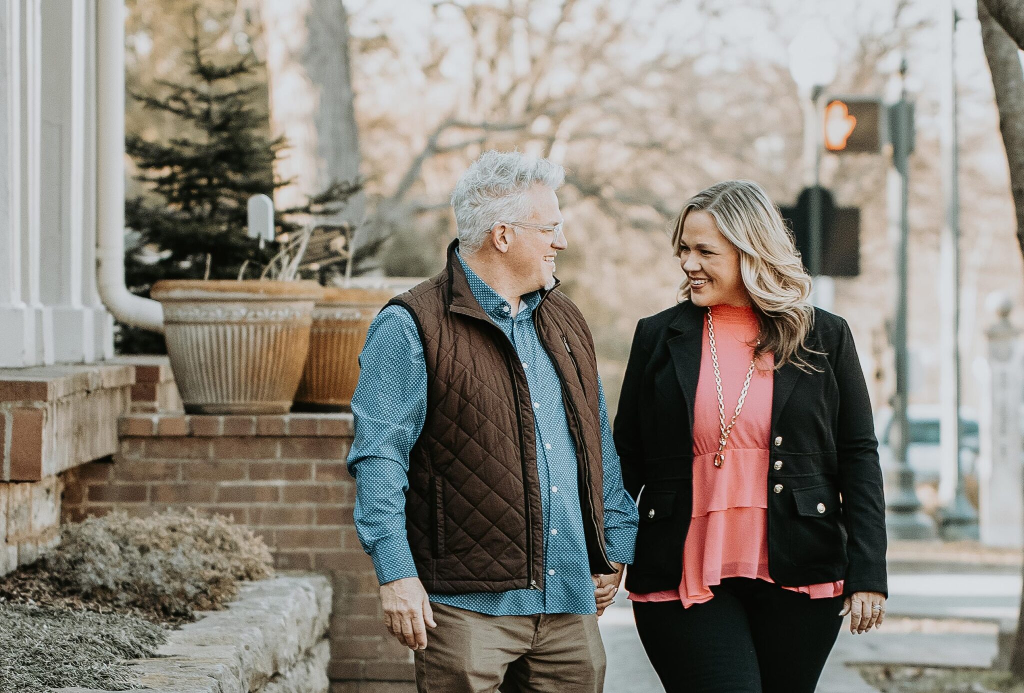 Keith and Megan walking down a tree-lined street